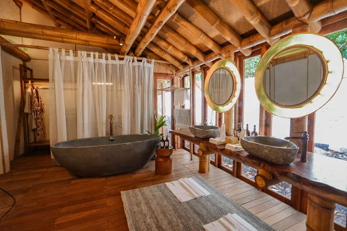 elang-lodge-bathroom-concrete-bath-sinks-mirrors-curtain